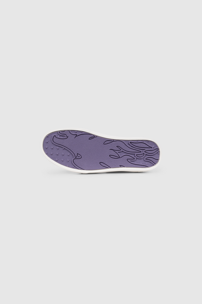 The PESOCLO Peso Skate features a purple sole with a wavy, abstract pattern and small star-shaped treads, showcased against a plain white background to highlight the unique sole artwork that distinguishes this design.