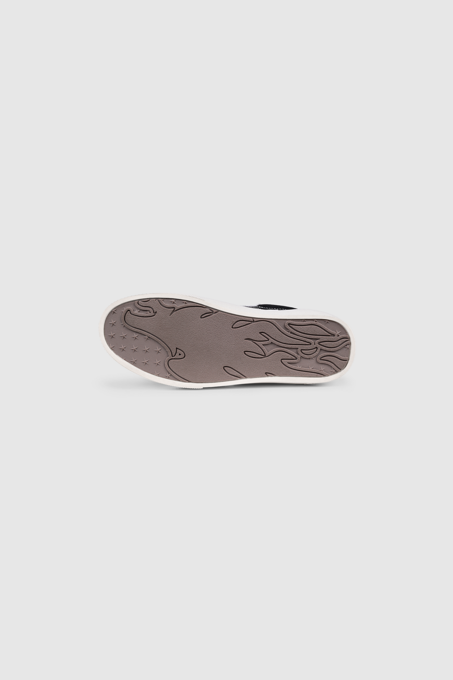 The image displays the gray sole of the PESOCLO Peso Skate shoe, featuring a decorative abstract pattern, as seen from the bottom against a plain light background. Along the edges, subtle glimpses of the artwork-inspired upper hint at the creative flair of this unique design.