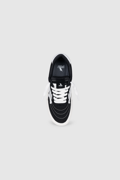 The PESOCLO Peso Skate sneaker is shown from above on a plain grey background, highlighting its black and white canvas-suede construction, white laces, white sole, and distinctive stitching around the toe. The PESOCLO brand logo is visible on the insole.