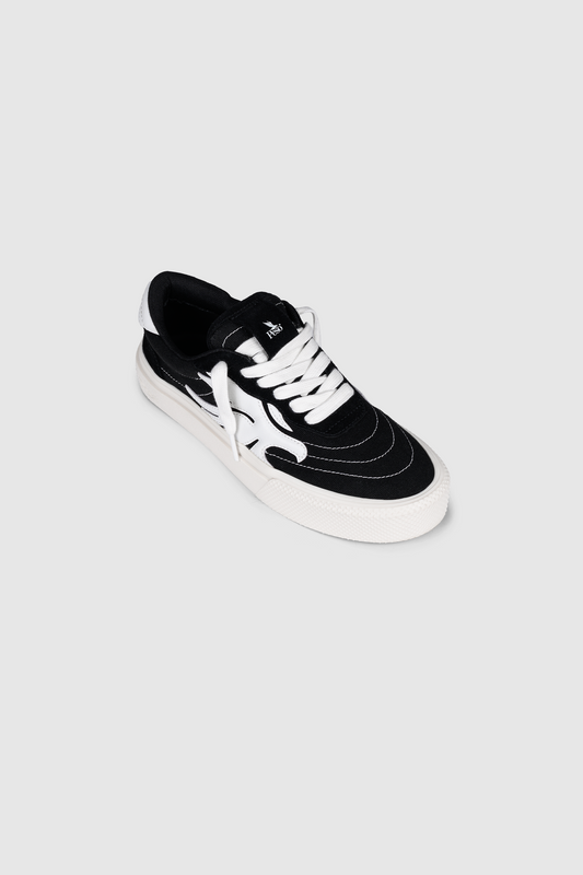The PESOCLO Peso Skate sneaker features an artwork upper crafted from a canvas-suede mix in black and white, with white laces and distinctive white graphic patterns on the sides, showcased against a plain light gray background.